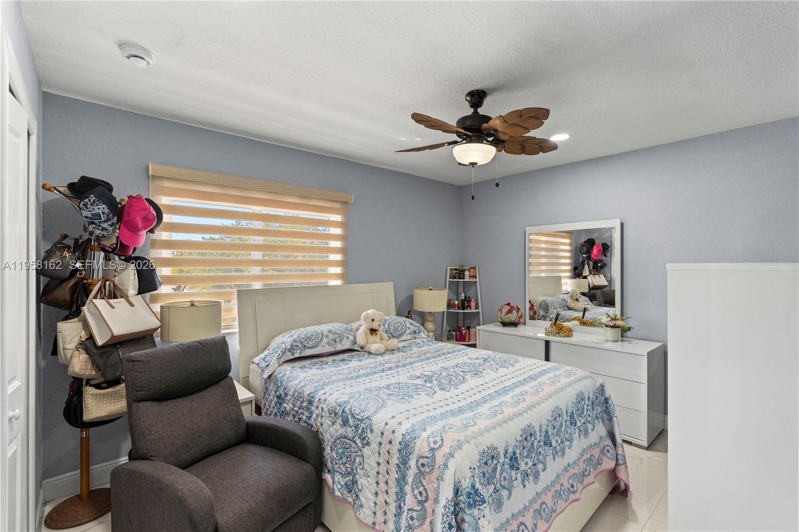 3281 Southwest 145th Avenue Miami, FL 33175 - Photo 45 of 56 a bedroom with a bed and a chandelier