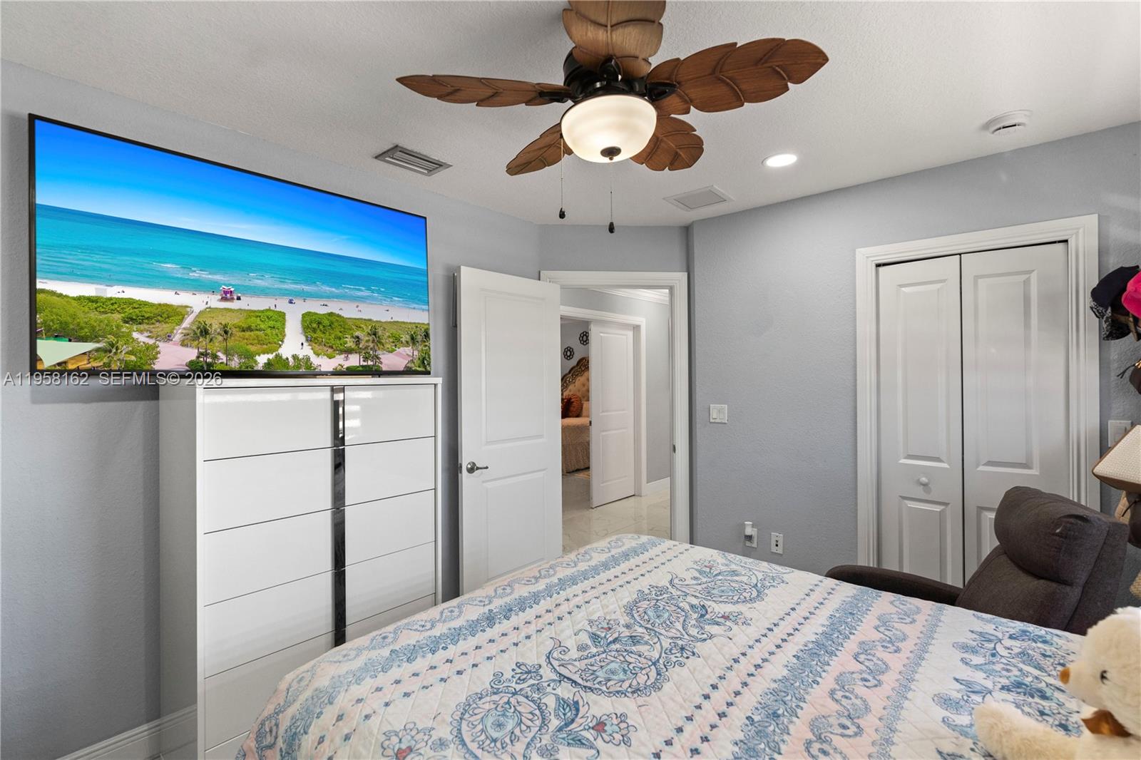3281 Southwest 145th Avenue Miami, FL 33175 - Photo 46 of 56 a bedroom with a bed and a chandelier