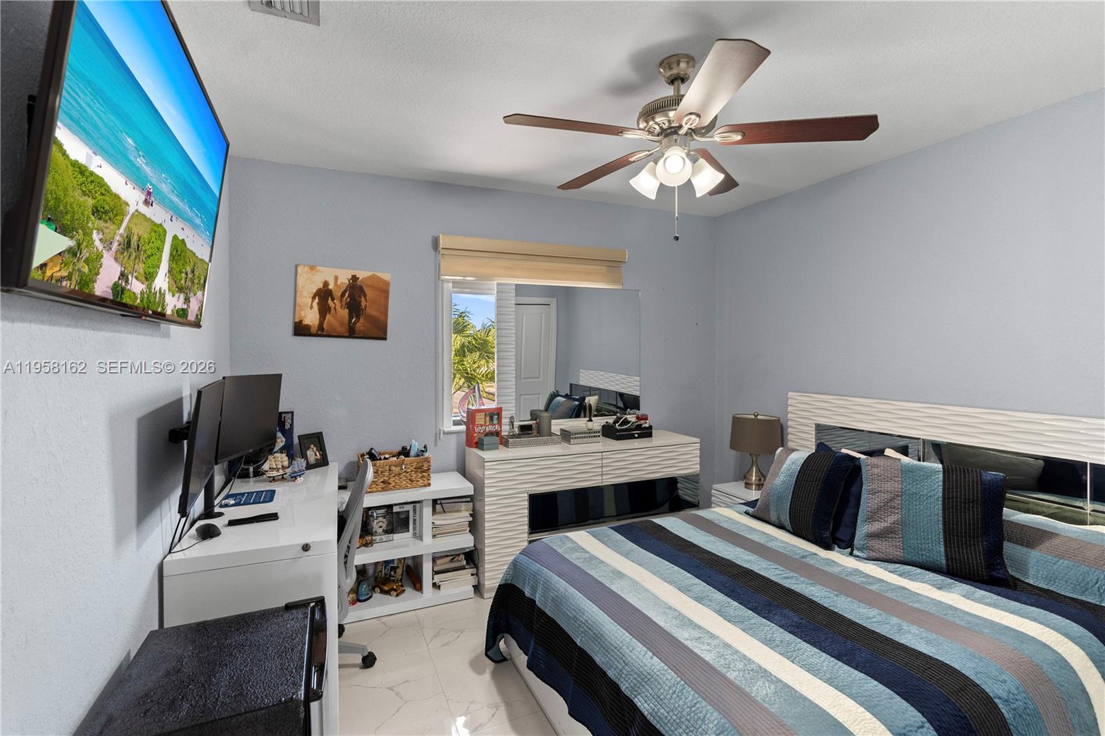 3281 Southwest 145th Avenue Miami, FL 33175 - Photo 47 of 56 a bedroom with a bed and a flat screen tv
