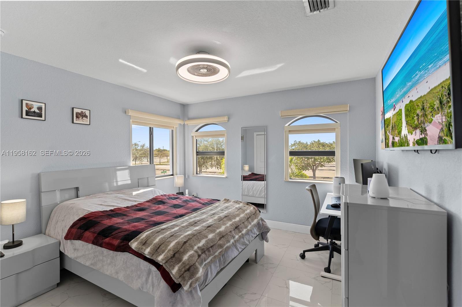 3281 Southwest 145th Avenue Miami, FL 33175 - Photo 49 of 56 a bedroom with a bed and a large window