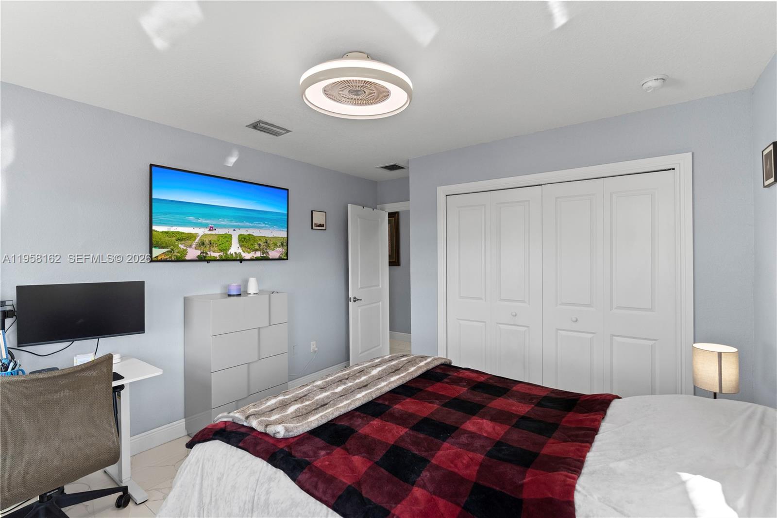 3281 Southwest 145th Avenue Miami, FL 33175 - Photo 50 of 56 a bedroom with a bed and a flat screen tv
