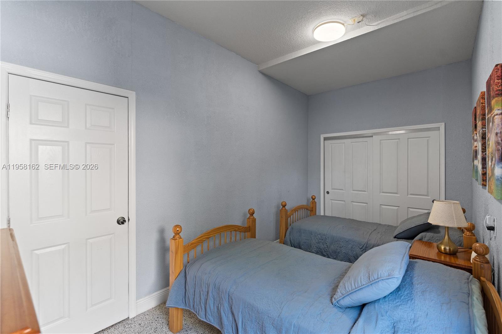 3281 Southwest 145th Avenue Miami, FL 33175 - Photo 53 of 56 a bedroom with a bed and wooden floor