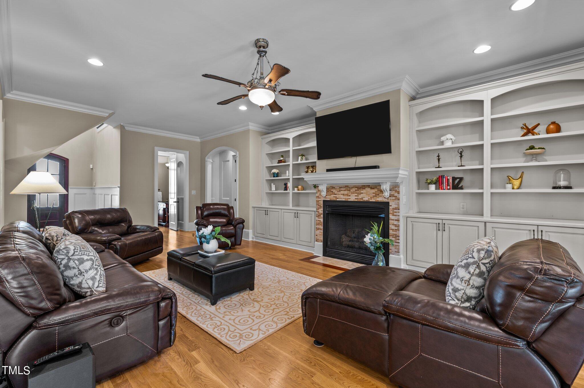2108 Cadenza Lane Raleigh, NC 27614 - Photo 18 of 43 Custom Built Ins, Recessed lighting, cozy fireplace. Through French Doors, this room accesses the four season's room with an additional stone fireplace