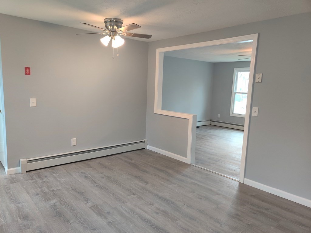 173 Wrentham Road Springfield, MA 01119 - Photo 5 of 15 wooden floor in an empty room with a window