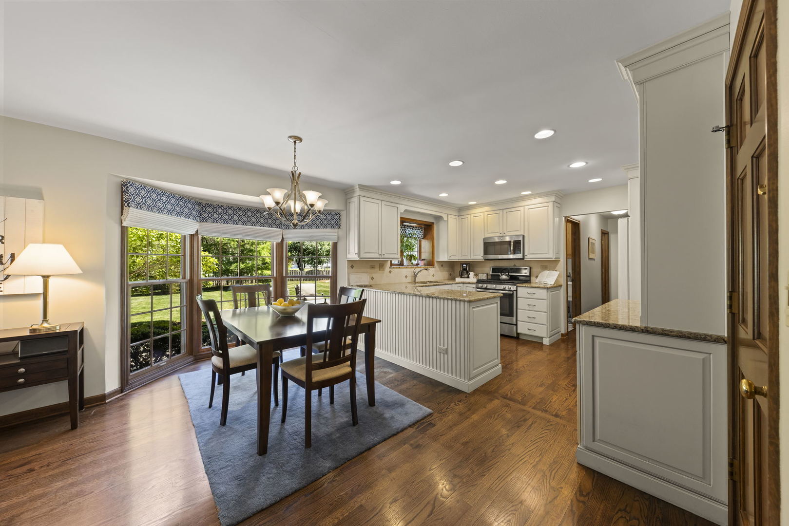 2037 Burnham Place Wheaton, IL 60189 - Photo 12 of 46 a dining room with furniture a floor to ceiling window and wooden floor
