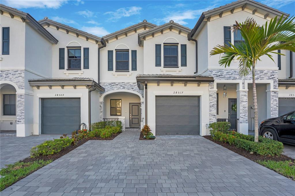 28517 Southwest 134th Avenue Homestead, FL 33033 - Photo 1 of 34 a front view of a house with a yard and garage