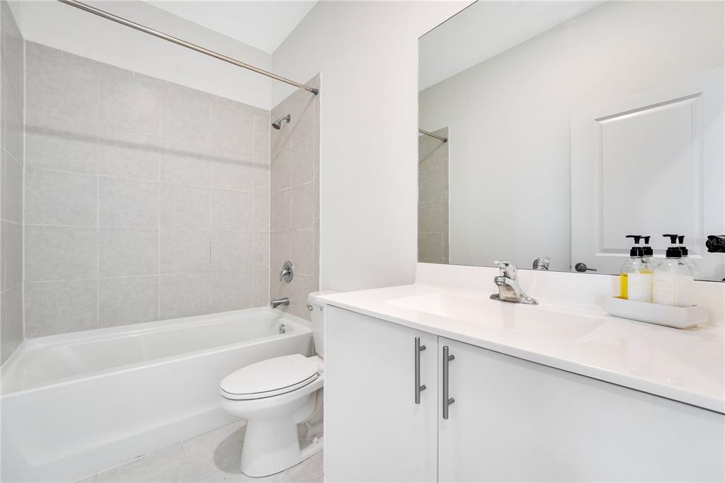 28517 Southwest 134th Avenue Homestead, FL 33033 - Photo 18 of 34 a bathroom with a sink a toilet and shower