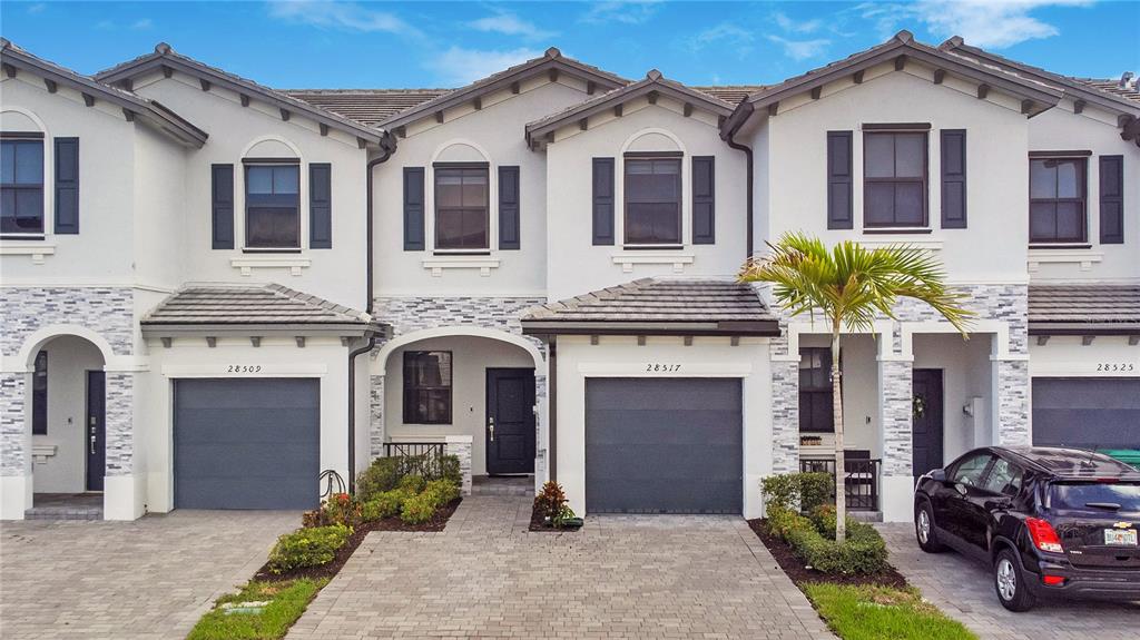 28517 Southwest 134th Avenue Homestead, FL 33033 - Photo 24 of 34 a front view of a house with yard and parking