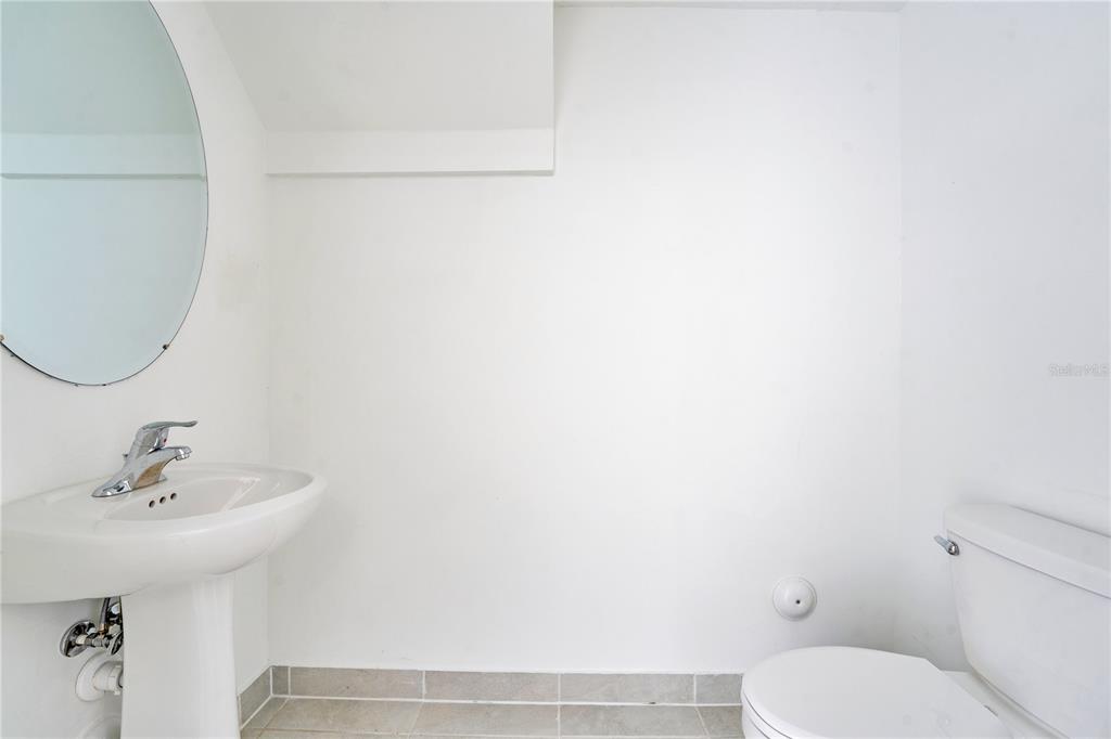 28517 Southwest 134th Avenue Homestead, FL 33033 - Photo 9 of 34 a bathroom with a sink a toilet and a mirror