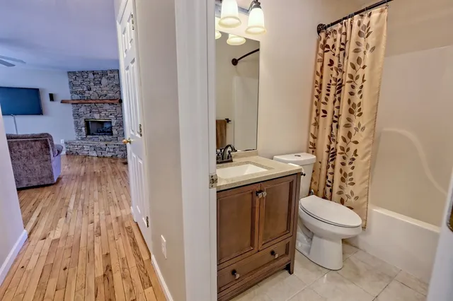 a view of a room with wooden floor and a toilet