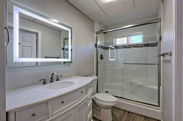 a view of a house with a yard and tree s