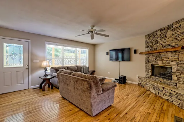 a living room with furniture and a fireplace