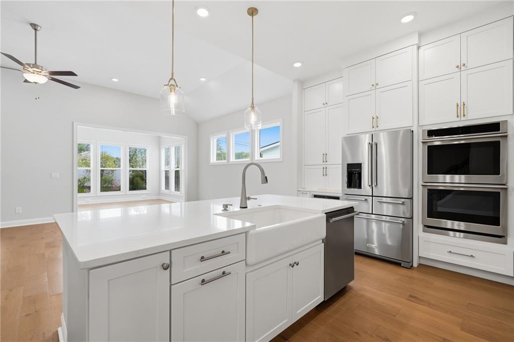 250 Idylwilde Way Canton, GA 30115 - Photo 12 of 59 a kitchen with kitchen island white cabinets and stainless steel appliances