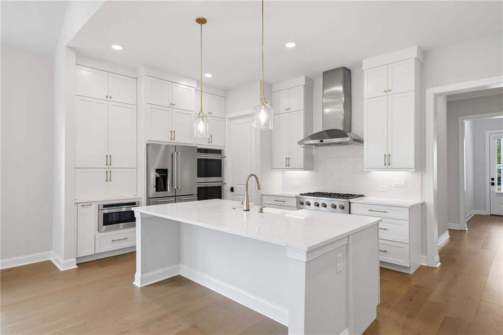 250 Idylwilde Way Canton, GA 30115 - Photo 18 of 59 a kitchen with stainless steel appliances kitchen island a sink stove and refrigerator