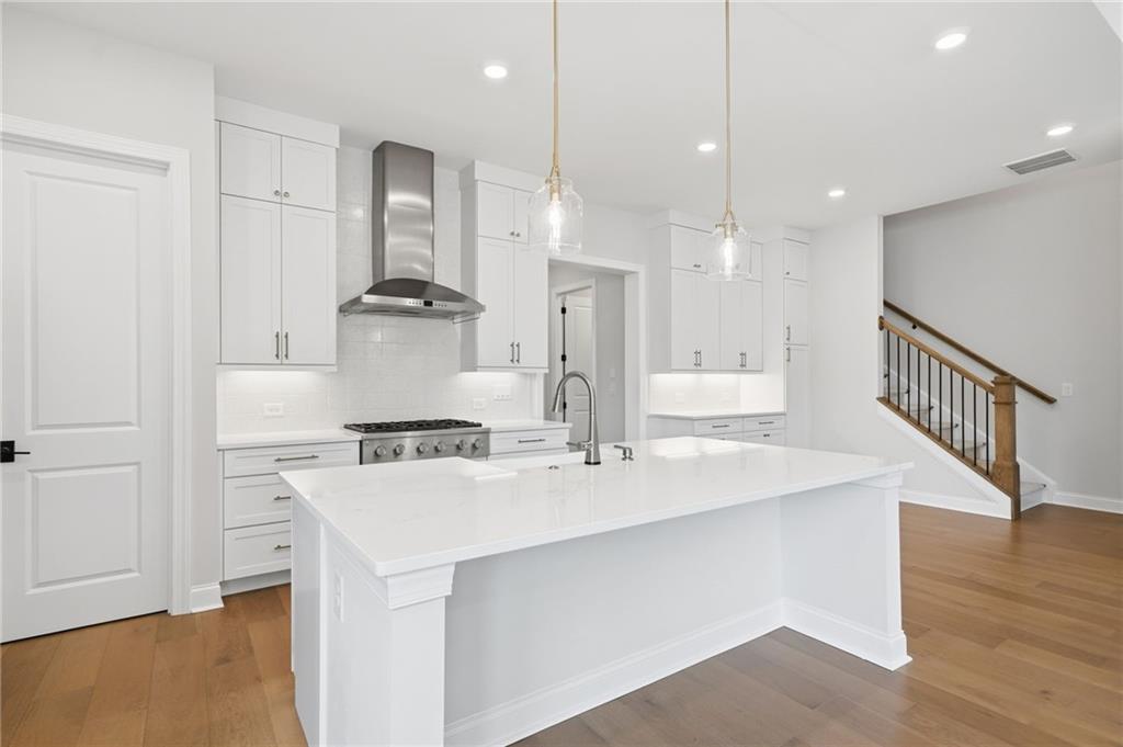250 Idylwilde Way Canton, GA 30115 - Photo 20 of 59 a kitchen with kitchen island a stove a sink and a refrigerator