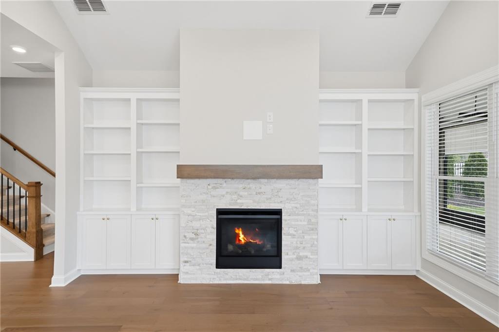 250 Idylwilde Way Canton, GA 30115 - Photo 24 of 59 a living room with a fireplace cabinet and a large window