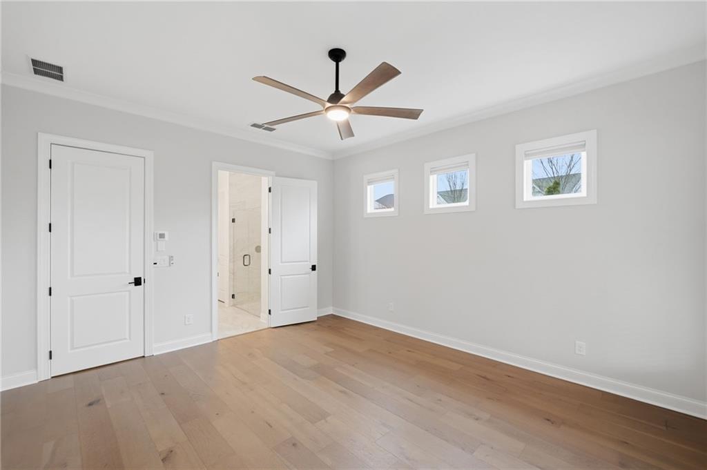 250 Idylwilde Way Canton, GA 30115 - Photo 30 of 59 an empty room with wooden floor ceiling fan and windows
