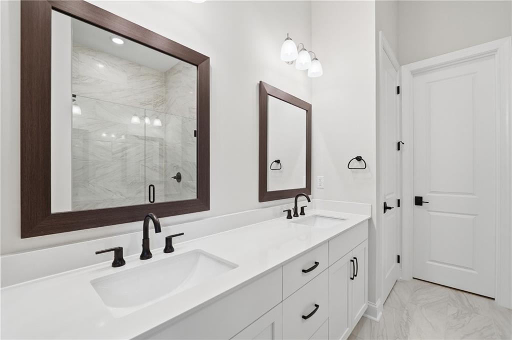 250 Idylwilde Way Canton, GA 30115 - Photo 32 of 59 a bathroom with double vanity sinks and a mirror