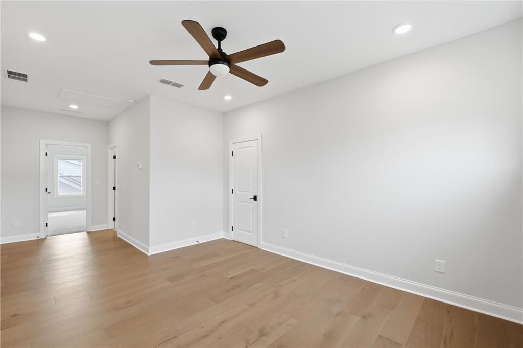 250 Idylwilde Way Canton, GA 30115 - Photo 38 of 59 an empty room with wooden floor and a ceiling fan
