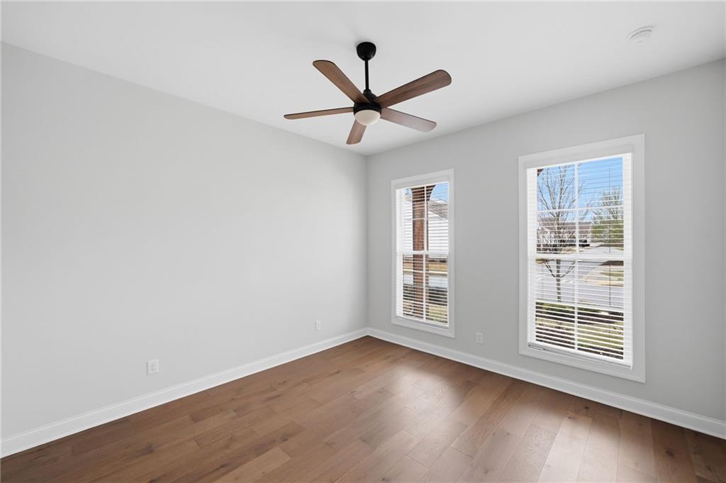 250 Idylwilde Way Canton, GA 30115 - Photo 5 of 59 an empty room with wooden floor fan and windows