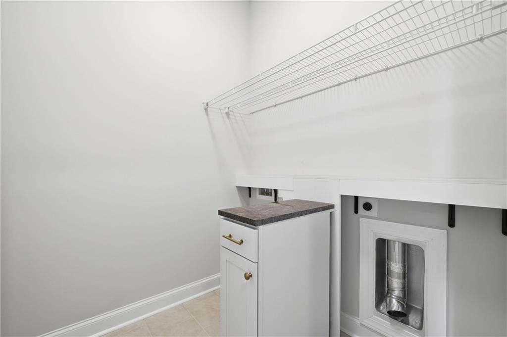 250 Idylwilde Way Canton, GA 30115 - Photo 10 of 59 a utility room with cabinets washer and dryer