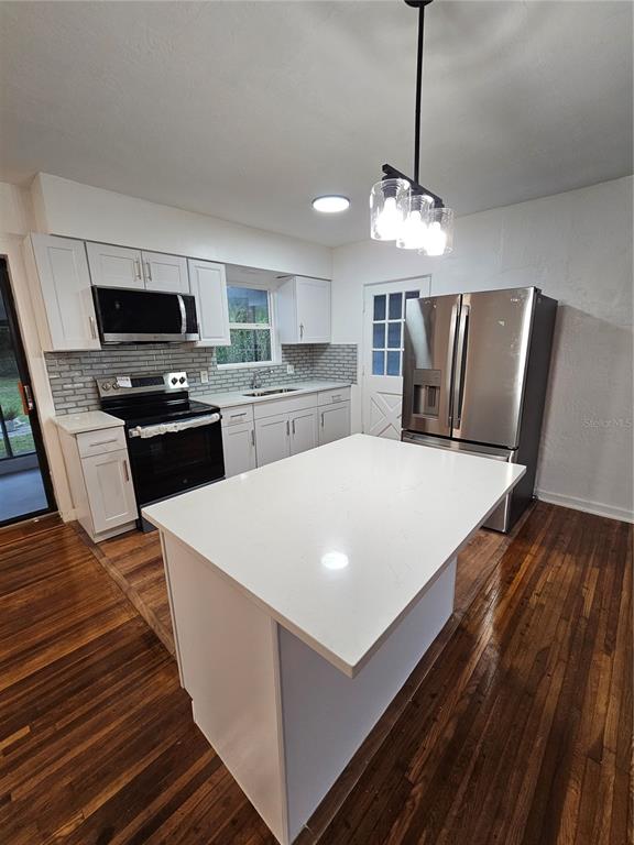 49 Azalea Drive DeBary, FL 32713 - Photo 8 of 25 a large white kitchen with a stove a sink dishwasher and a refrigerator