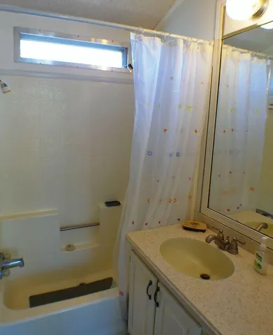 a room with sink and mirror