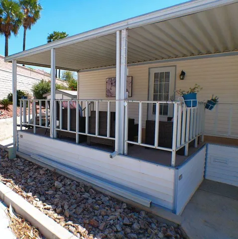 a view of a house with a wooden deck