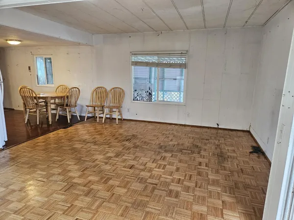 a kitchen with stainless steel appliances granite countertop a refrigerator a sink a stove and a refrigerator