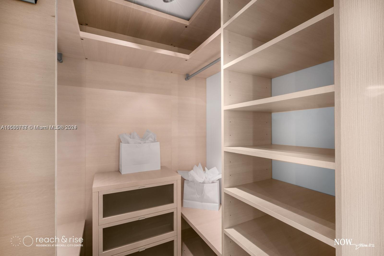 88 Southwest 7th Street, Unit 1403 Miami, FL 33130 - Photo 11 of 15 a room with walk in closet and wooden floor