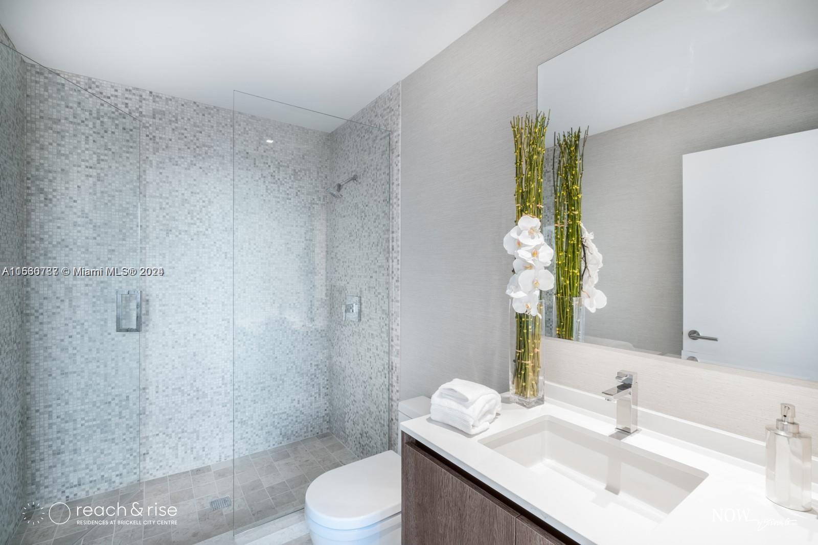 88 Southwest 7th Street, Unit 1403 Miami, FL 33130 - Photo 13 of 15 a bathroom with a sink toilet and shower