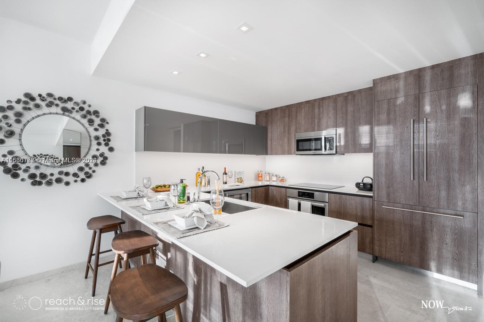 88 Southwest 7th Street, Unit 1403 Miami, FL 33130 - Photo 4 of 15 a kitchen with a table chairs sink and cabinets