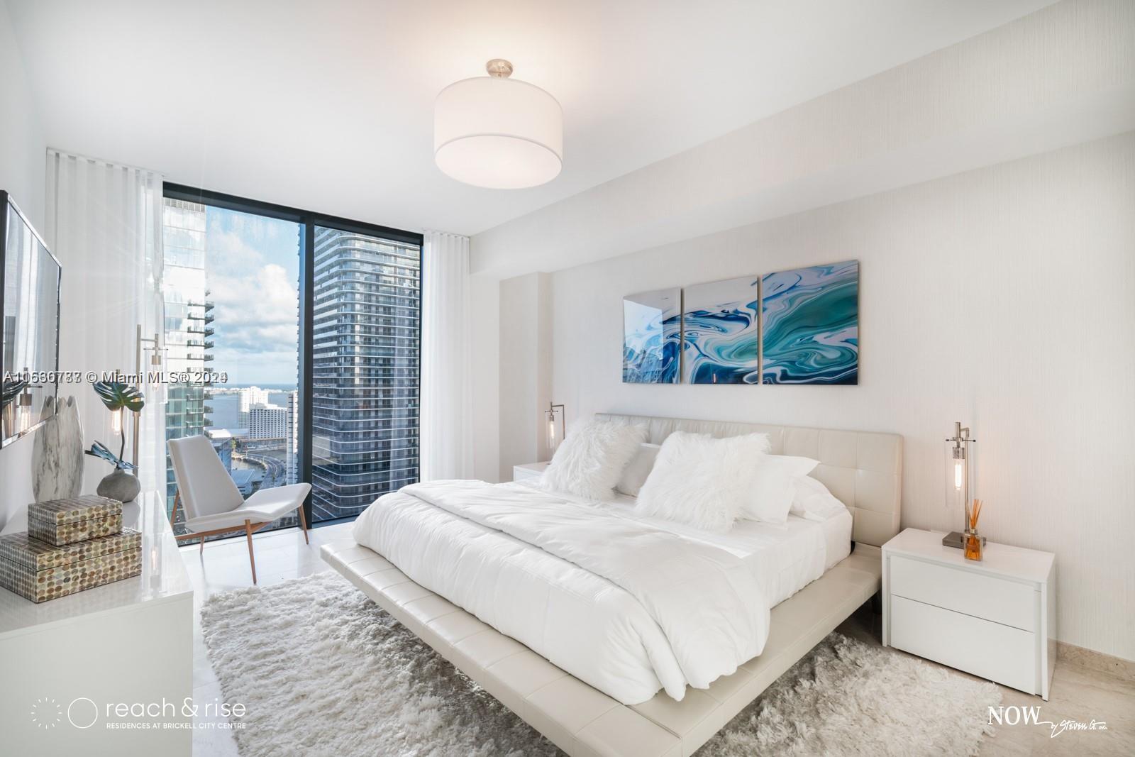 88 Southwest 7th Street, Unit 1403 Miami, FL 33130 - Photo 7 of 15 a bedroom with a large bed and a large window