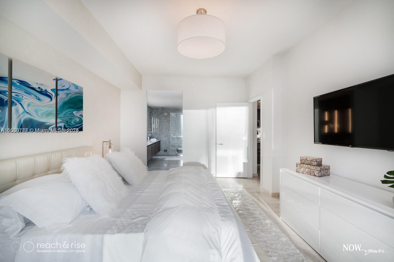 88 Southwest 7th Street, Unit 1403 Miami, FL 33130 - Photo 9 of 15 a large white bed in a white room