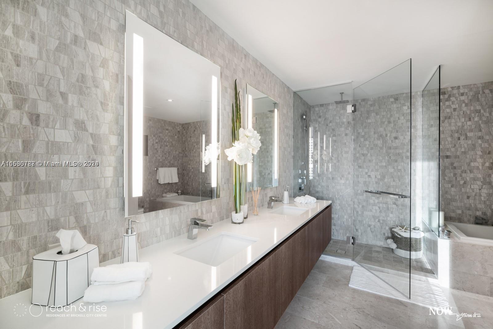 88 Southwest 7th Street, Unit 1403 Miami, FL 33130 - Photo 10 of 15 a bathroom with a double vanity sink mirror and bathtub