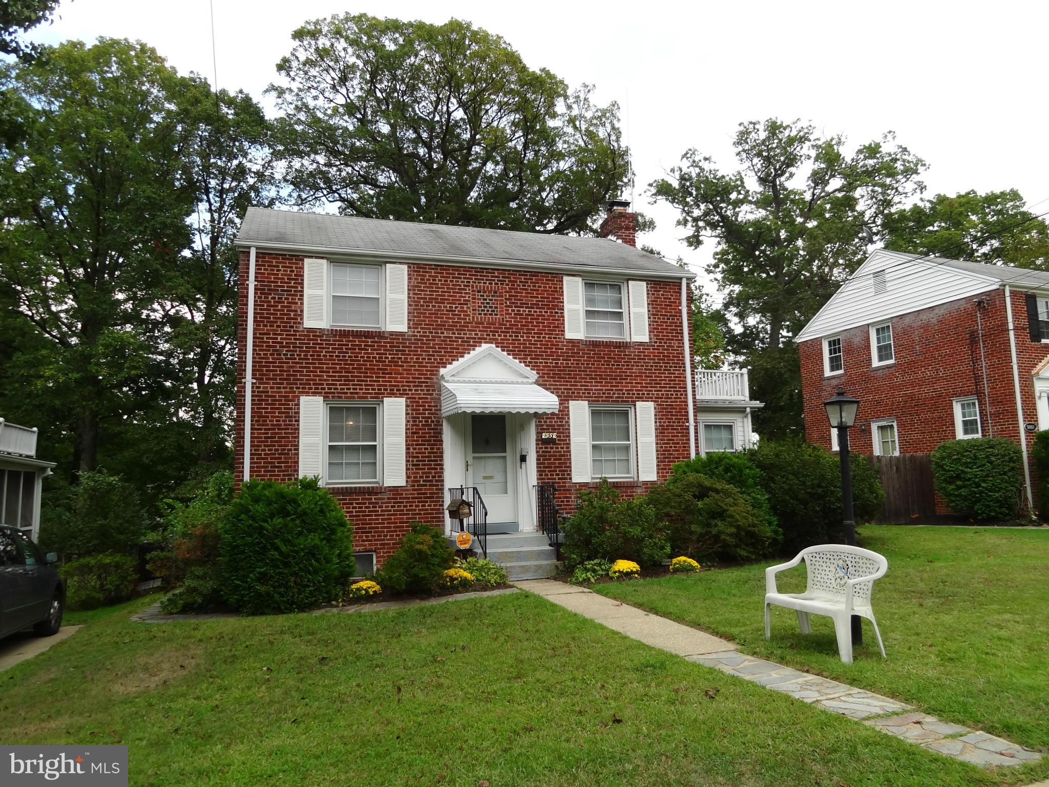 9009 Walden Road Silver Spring, MD 20901 - Photo 2 of 22 a front view of a house with a yard and trees
