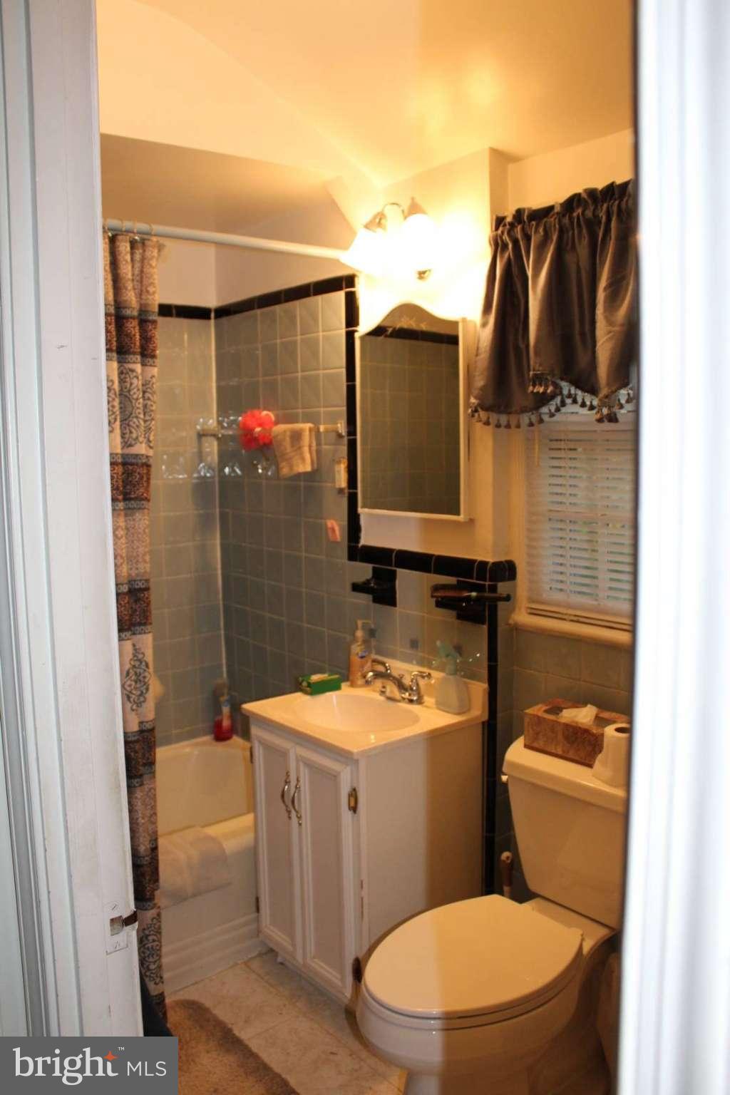 9009 Walden Road Silver Spring, MD 20901 - Photo 13 of 22 a bathroom with a toilet a sink and a shower