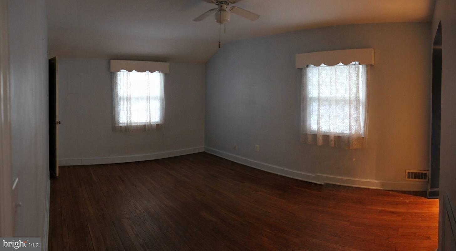 9009 Walden Road Silver Spring, MD 20901 - Photo 14 of 22 a view of an empty room with wooden floor and a window