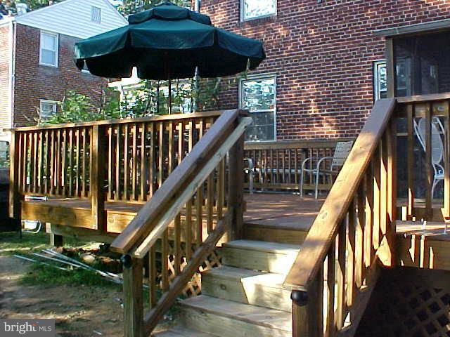 9009 Walden Road Silver Spring, MD 20901 - Photo 22 of 22 a view of deck with chairs and umbrella