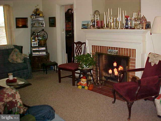 9009 Walden Road Silver Spring, MD 20901 - Photo 4 of 22 a living room with furniture and a fireplace