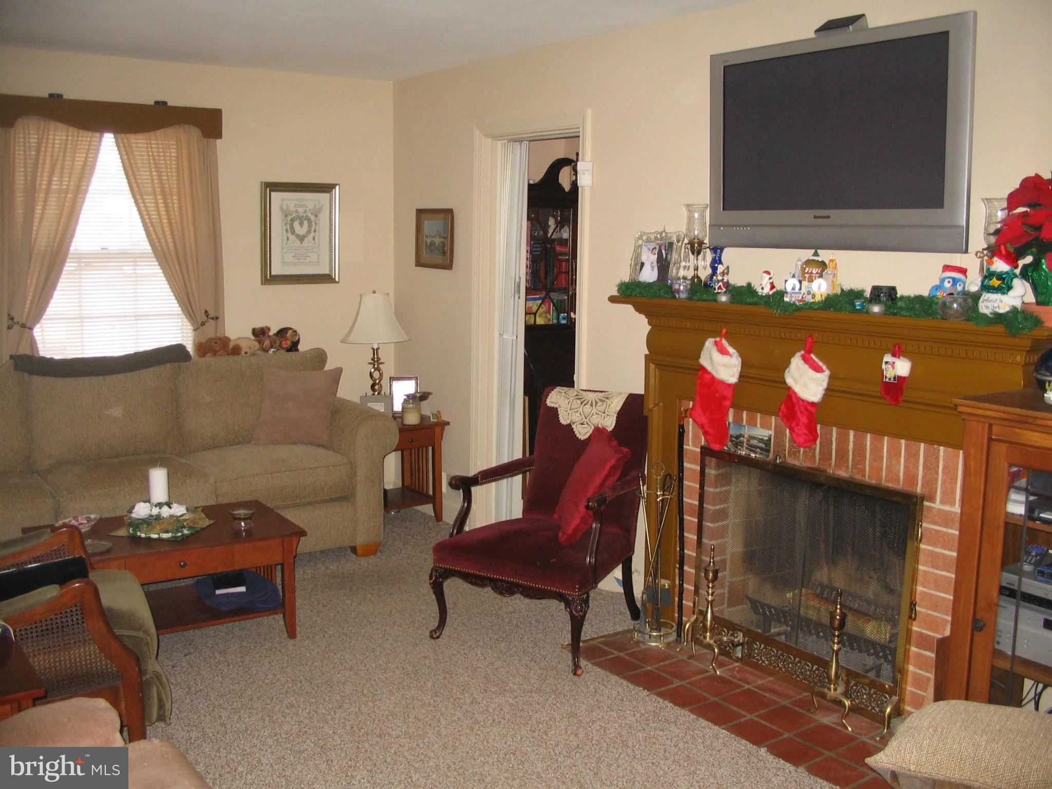 9009 Walden Road Silver Spring, MD 20901 - Photo 5 of 22 a living room with furniture and a flat screen tv