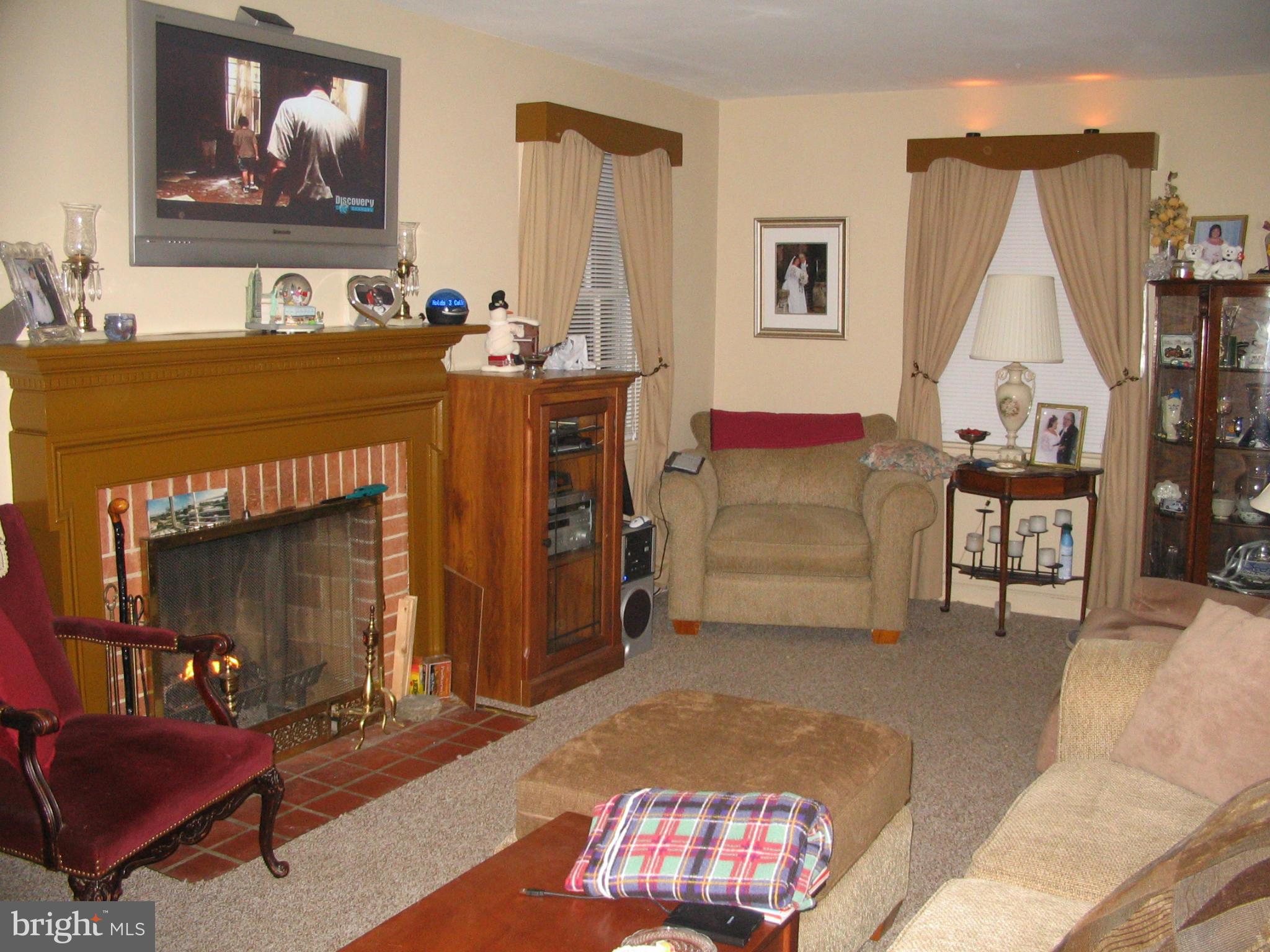 9009 Walden Road Silver Spring, MD 20901 - Photo 6 of 22 a living room with furniture and a fireplace