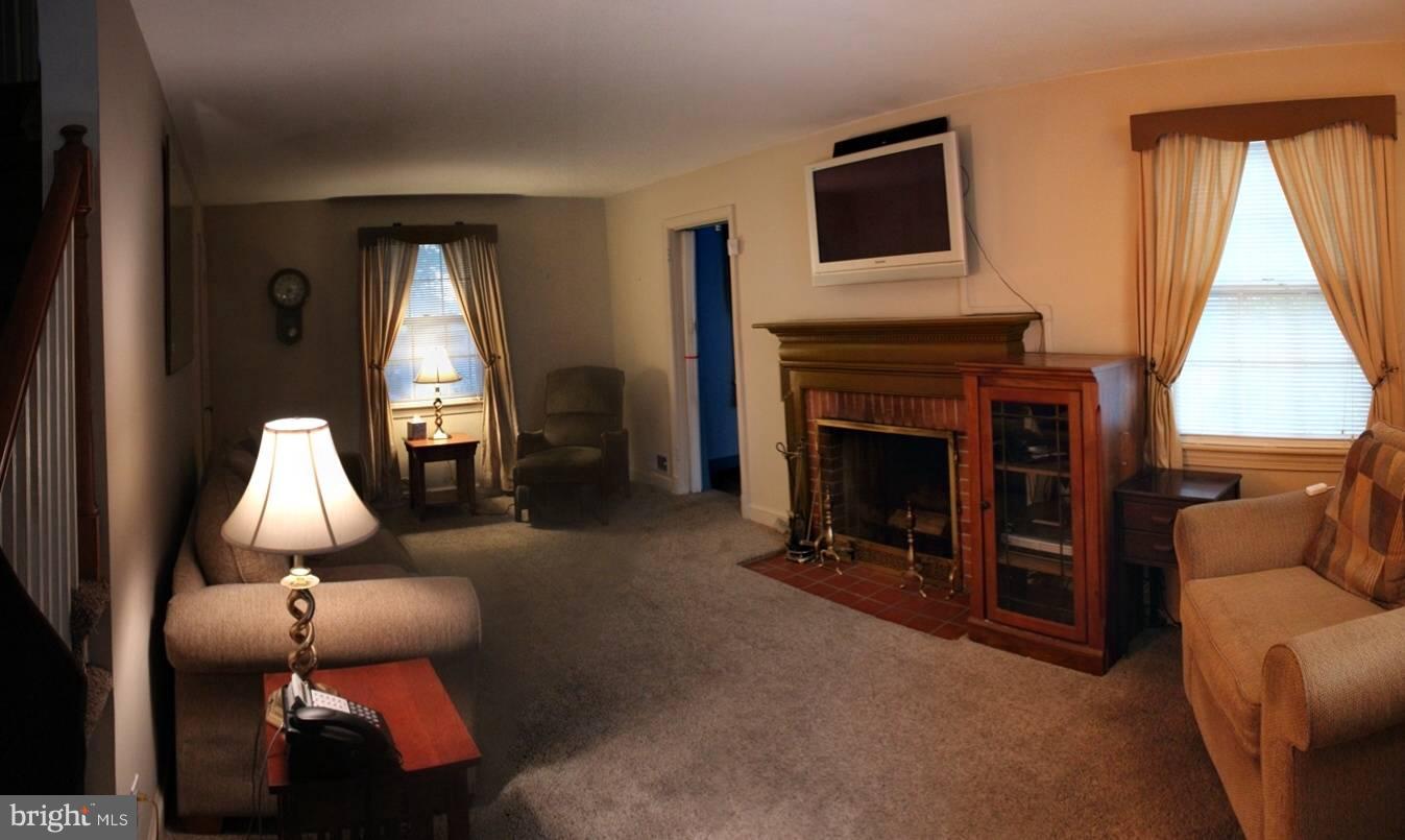 9009 Walden Road Silver Spring, MD 20901 - Photo 7 of 22 a living room with furniture and a fireplace