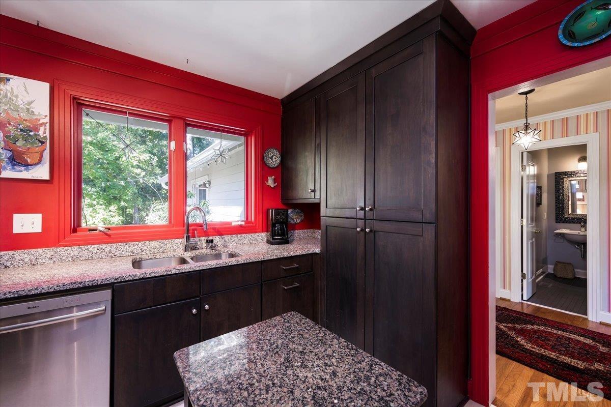 1311 Ridge Road Raleigh, NC 27607 - Photo 14 of 21 a kitchen with stainless steel appliances granite countertop a stove a sink and a refrigerator