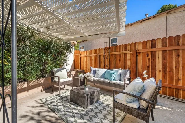 a view of a backyard with large trees and wooden fence