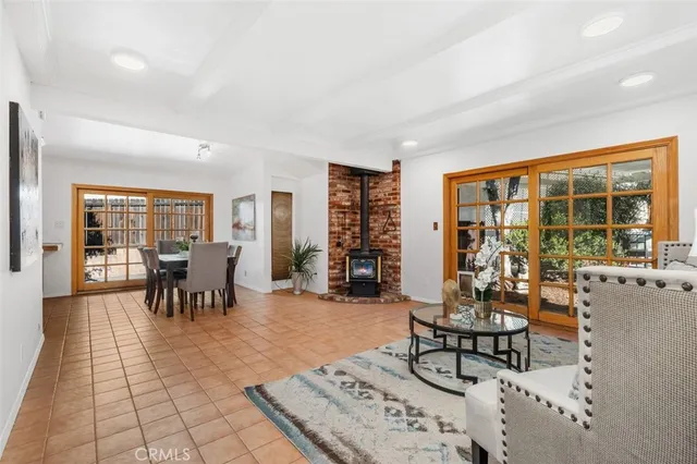a living room with furniture and large windows