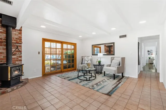 a living room with furniture a flat screen tv and a window