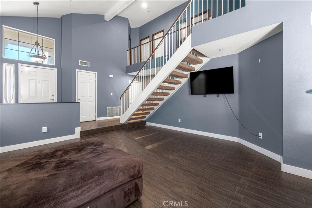 15417 Tobarra Road Fontana, CA 92337 - Photo 6 of 29 a view of an empty room with a window and wooden floor