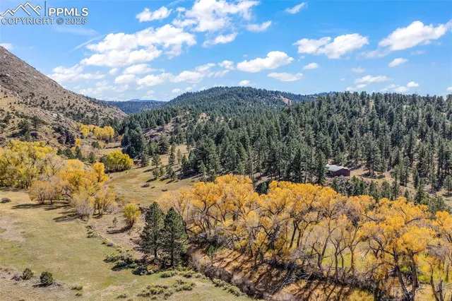 a view of a dry yard with mountains