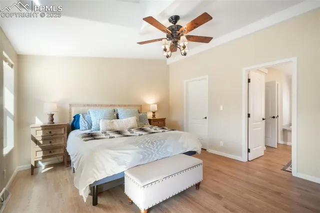 a bedroom with a bed and dresser with mirror